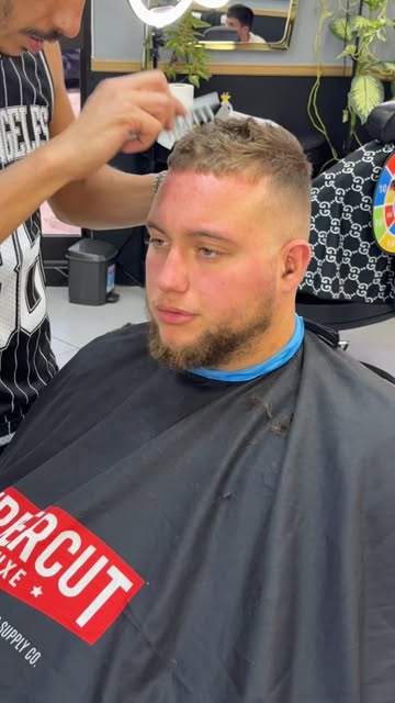 Seven17 barber working on a fade