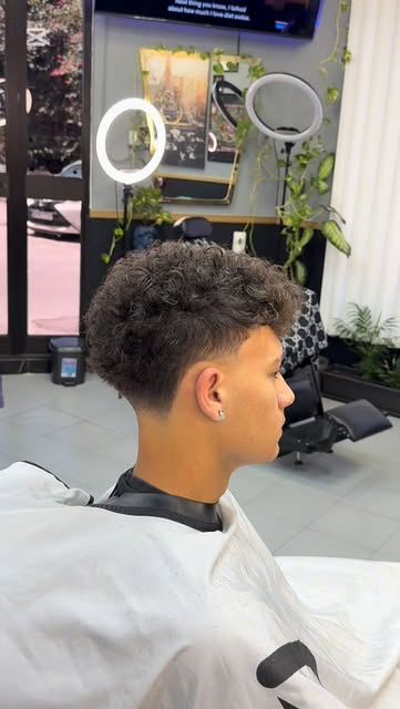 Textured curls with a low fade at Seven17